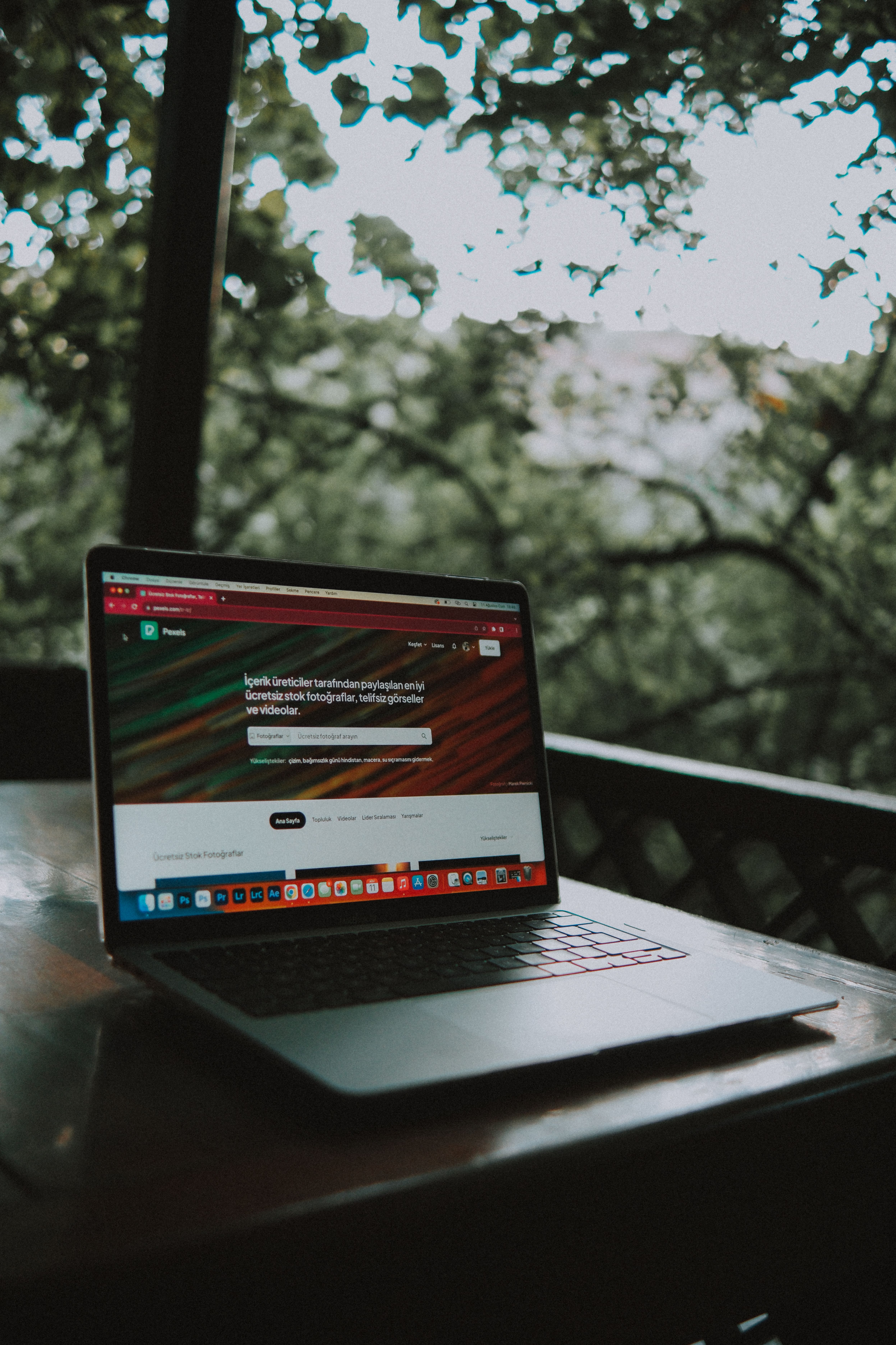 Laptop on a wooden table in an outdoor workspace